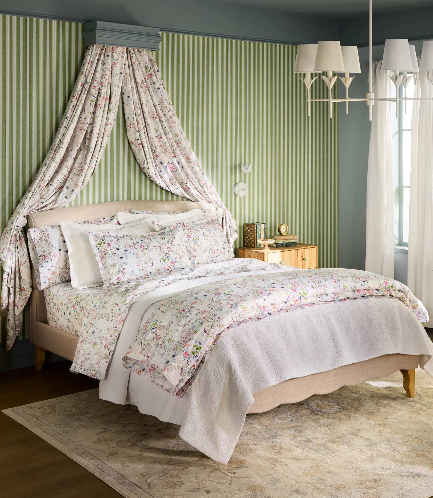 Chloe percale duvet and shams on a bed against a draped, green stripe accent wall
