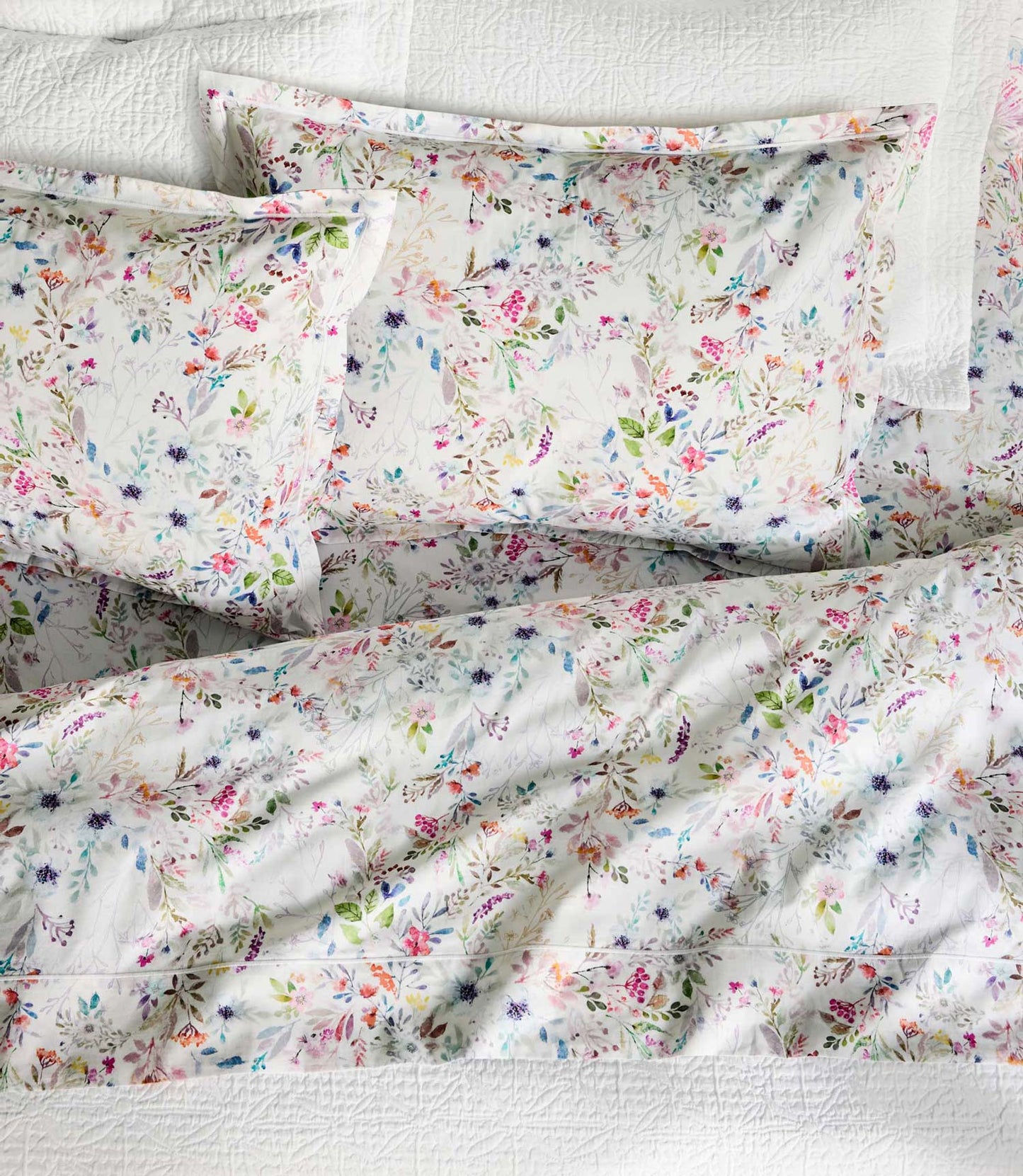 Chloe floral sheet set on bed with white coverlet, Floral