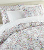chloe percale duvet and sham on a bed with a cream colored headboard, Floral
