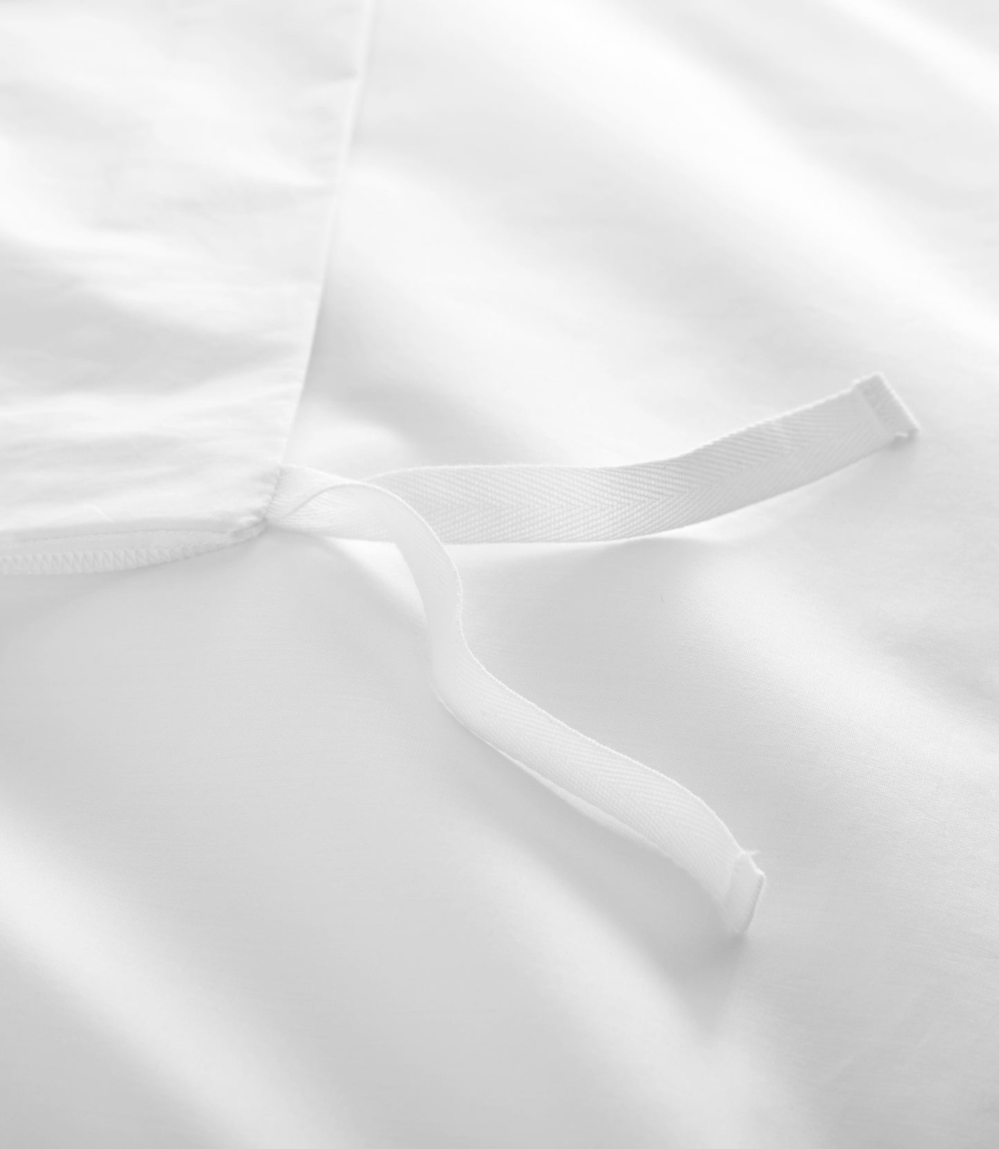 Close-up of a white duvet cover ties