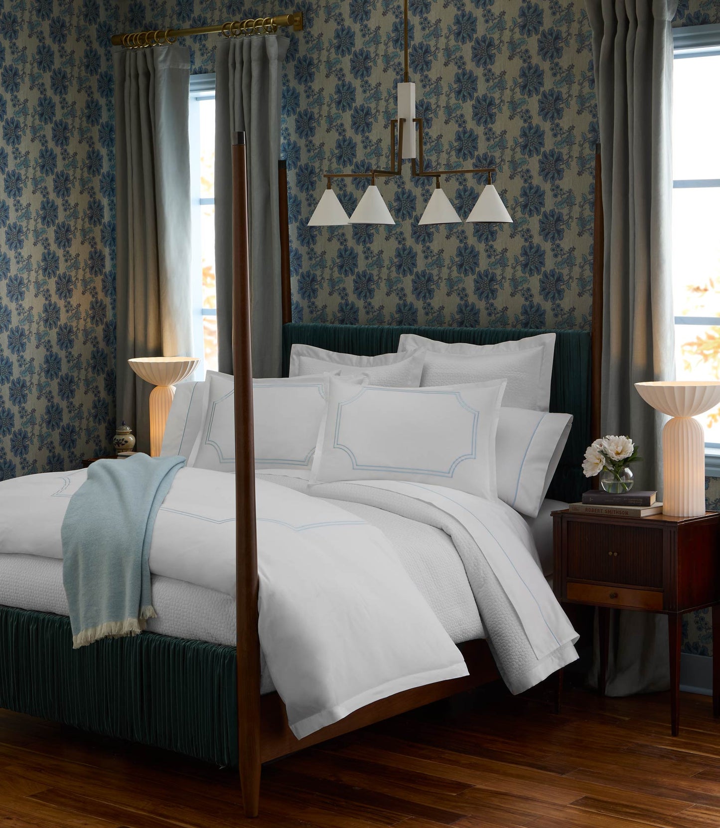 Deco Classic Embroidered Duvet Set on a canopy bed in a room with floral wallpaper and dark wood floors.