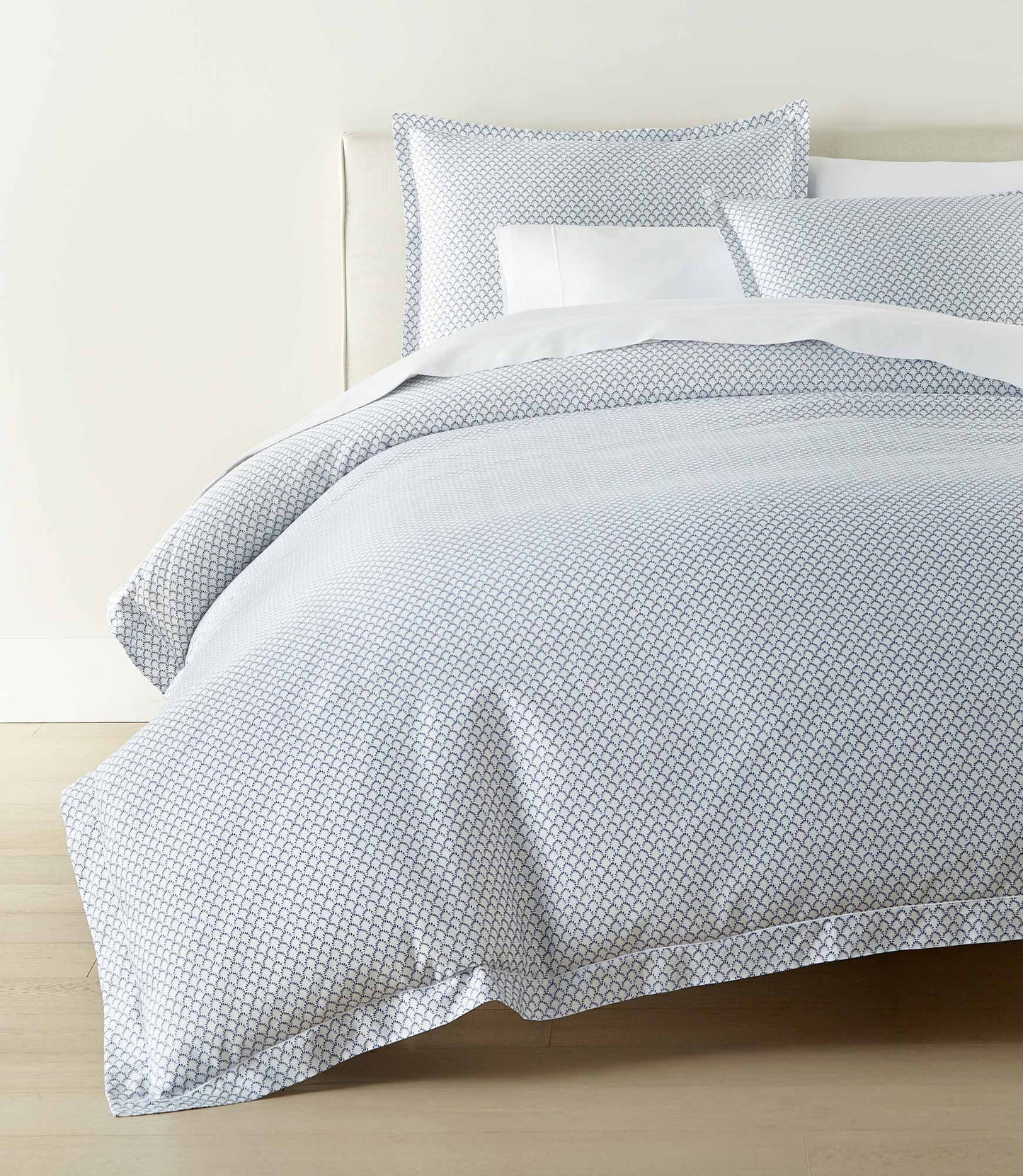 Demi printed cotton sateen duvet and shams set on bed with white sheets, Demi Navy