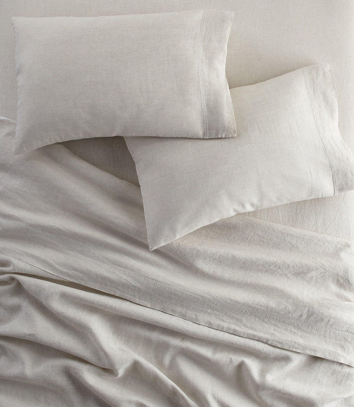 European Washed Linen Flat Sheet and pillows on bed, Natural