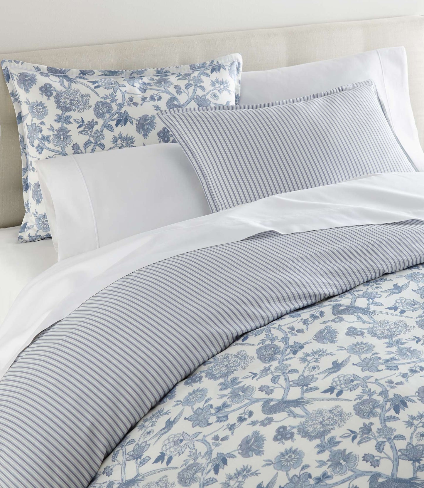 Highgrove Toile Duvet Set Highgrove Wedgewood on a bed with cream colored headboard