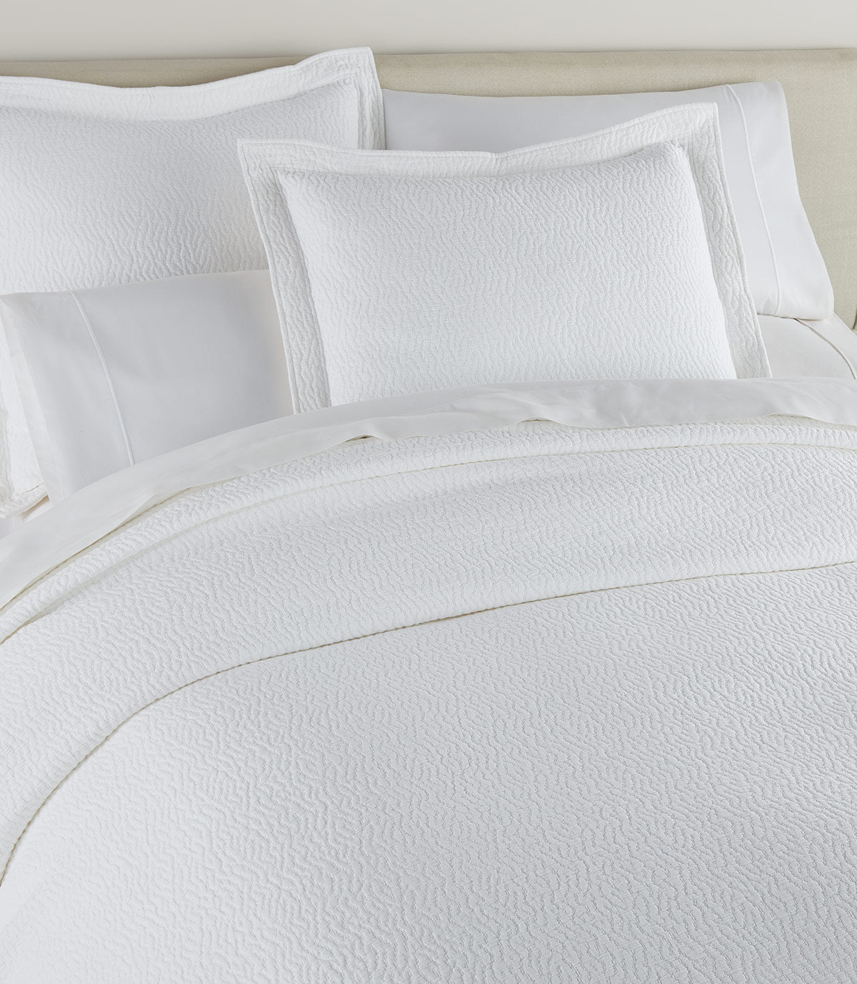 Mia Stonewashed Matelassé Shams on bed, White