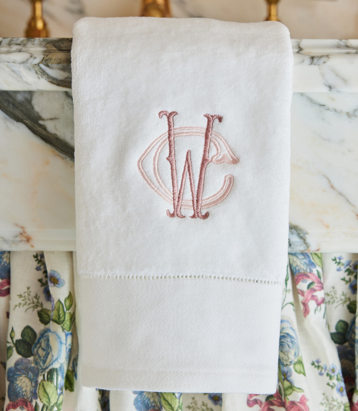 Special Occasion Hand Towel with pink embroidered monogram on a marble surface