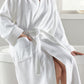 woman in white bath robe hand in pocket