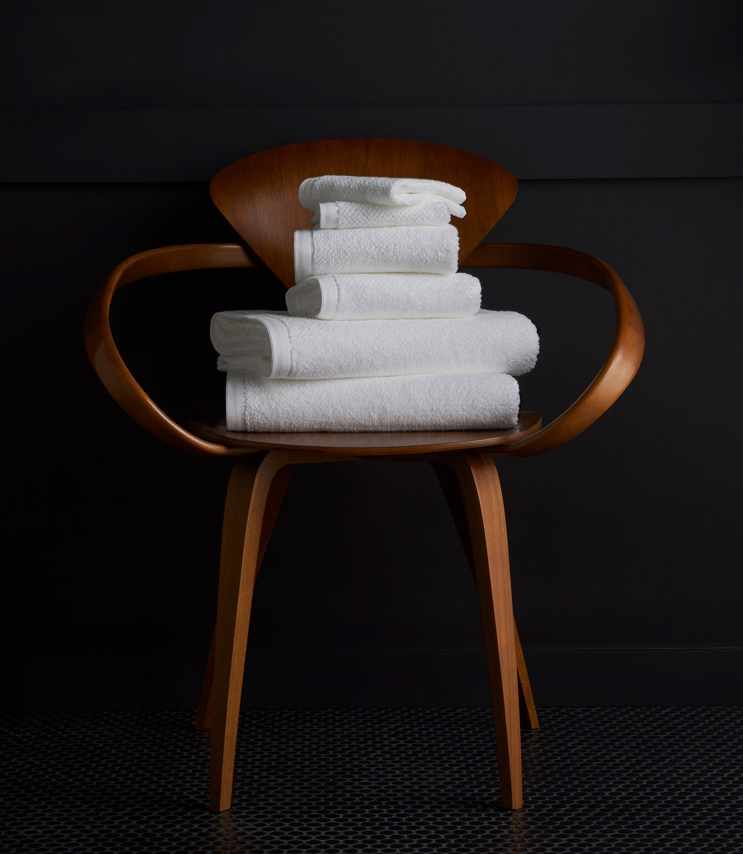Jubilee Towel Set Detail Shot of White Bath Towels on a Wood Chair