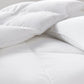 Down alternative mattress enhancer folded on bed White