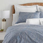 Blue paisley pillow shams and duvet cover on bed
