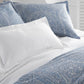 Blue coastal paisley duvet cover and shams on bed detail