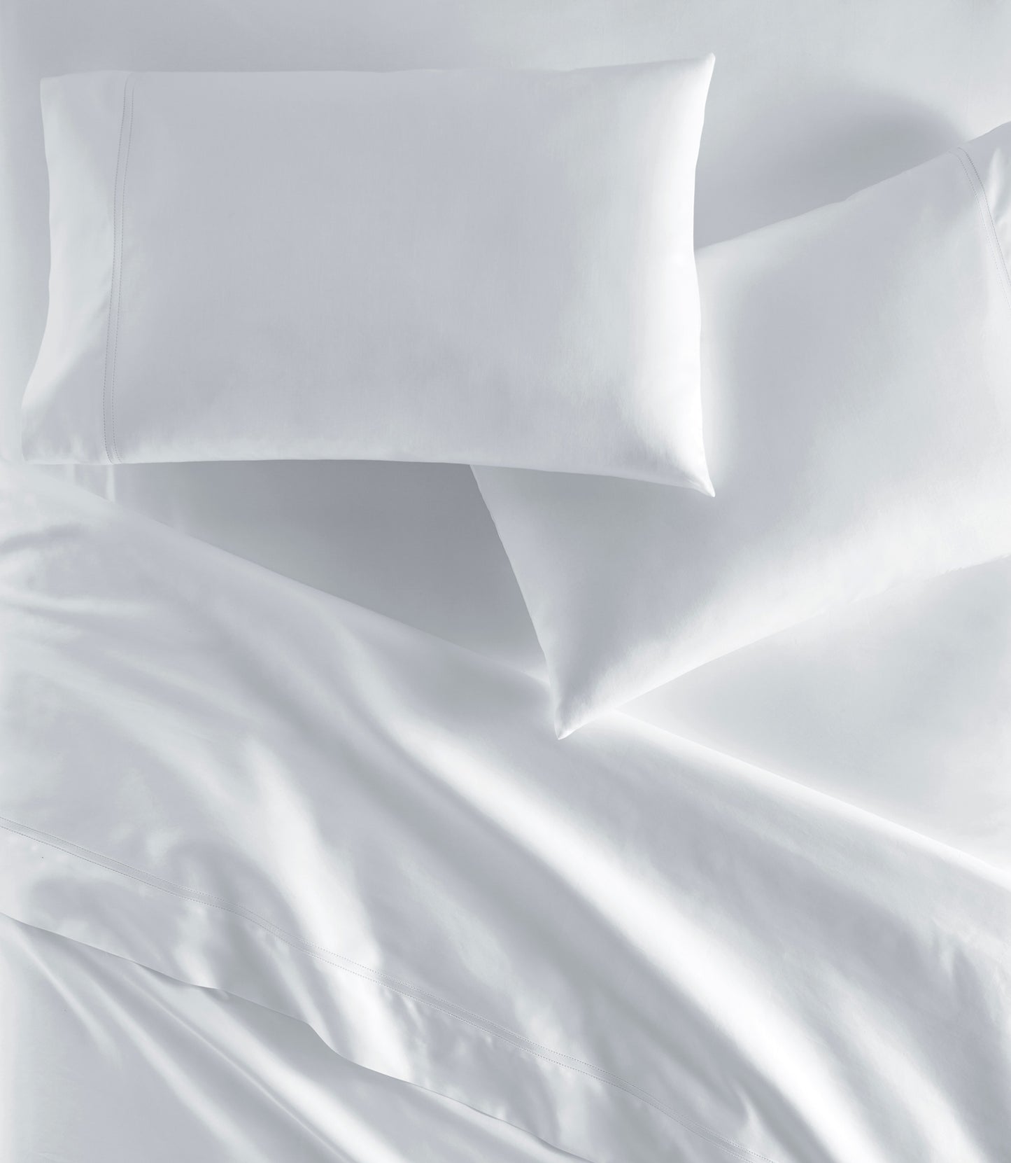 Virtuoso Sateen Pillowcases on Bed White