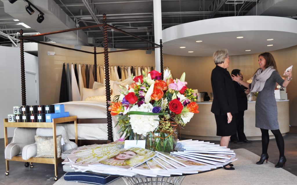 Peacock Alley's Atlanta Design Studio featuring a brightly colored floral arrangement on a table of catalogs