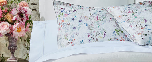 White sheets behind Chloe floral sham | Peacock Alley