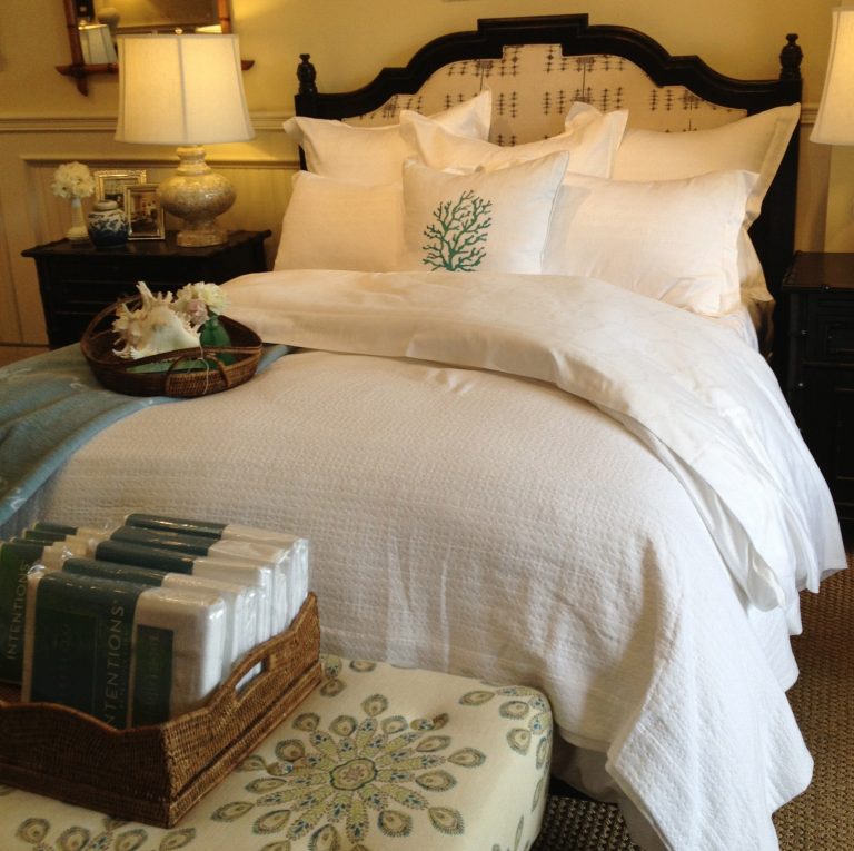 Classic bed styled primarily in white with green accents