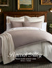 A 'Peacock Alley Price Guide August 2026' watermark atop a styled bed with platinum duvet and shams.