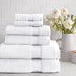 Diamond Bath Towels Stacked in white on a white countertop and a tiled background. 