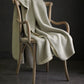 Alta Reversible Cotton Blanket On A Chair Pearl