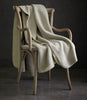 Alta Reversible Cotton Blanket On A Chair Pearl