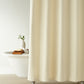 Alyssa Matelassé Shower Curtain in a bathroom setting with a bathtub and plant, Natural