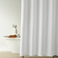 Alyssa Matelassé Shower Curtain in a bathroom setting with a bathtub and plant, White