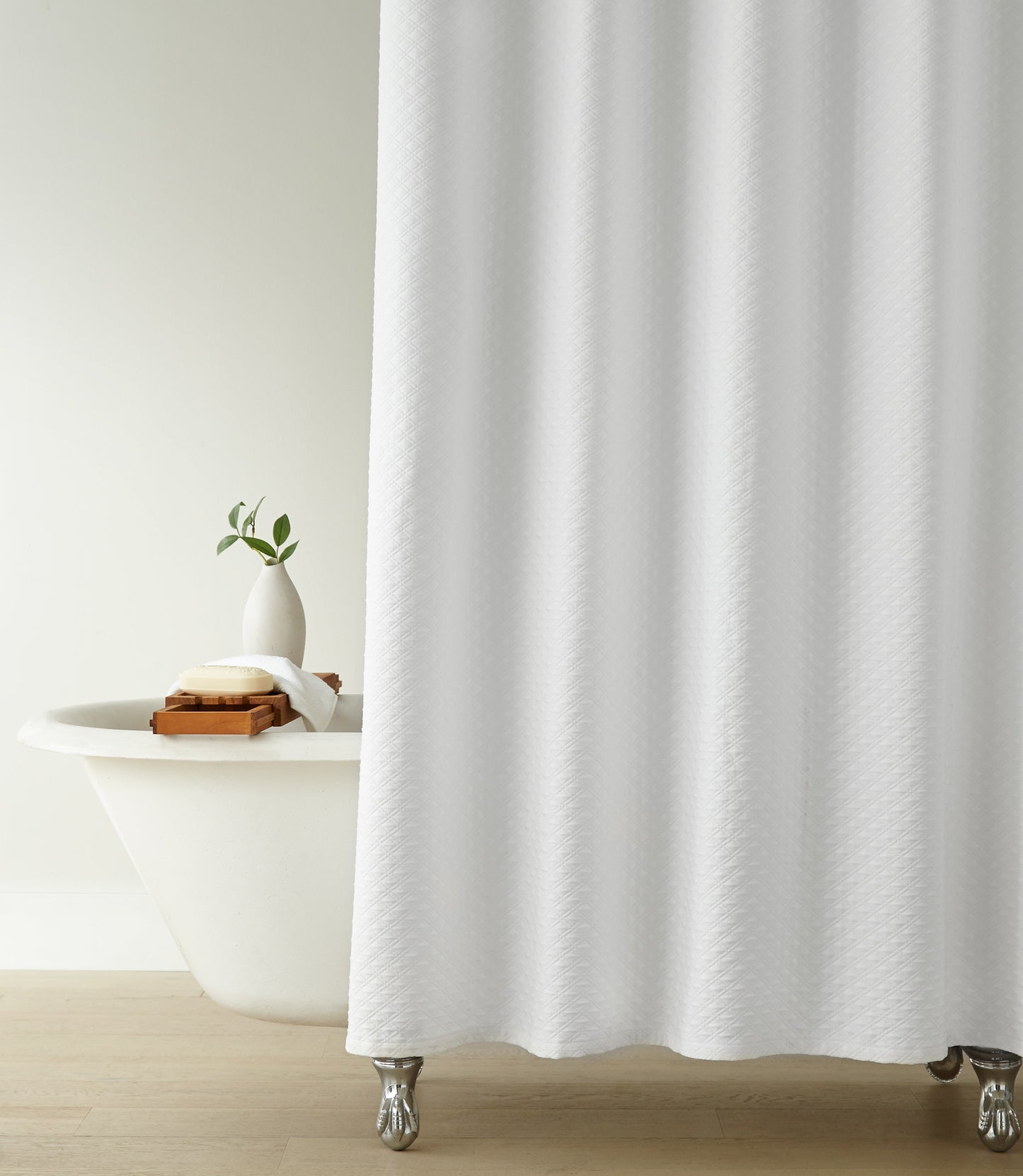 Alyssa Matelassé Shower Curtain in a bathroom setting with a bathtub and plant, White