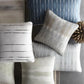 carol benson cobb pillow collection on  gray table