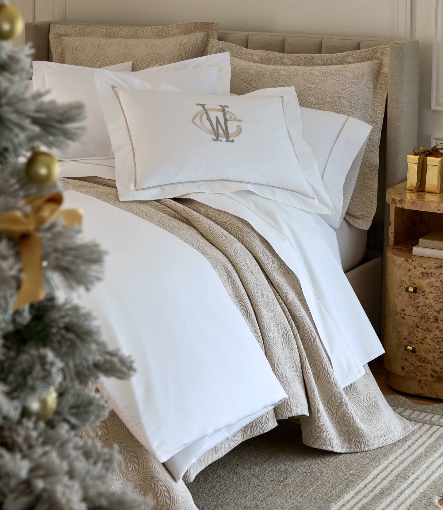 Vienna Coverlet displayed on a bed with an embroidered white sham