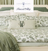 Caitlin Wilson for Peacock Alley logo on top of a green duvet lifestyle image, Shop the Collection