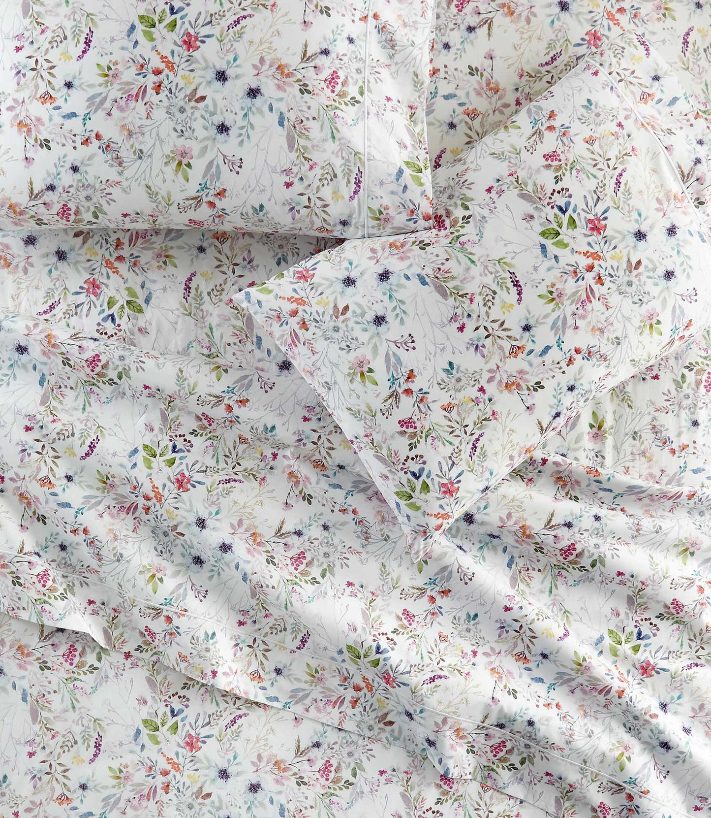 Chloe percale floral print pillowcases and sheets on a bed, Floral