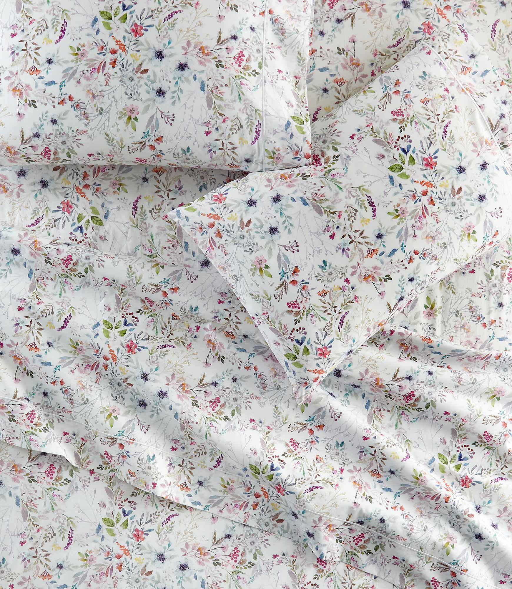 Chloe percale floral print pillowcases and sheets on a bed, Floral