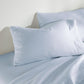 Clara Sateen Sheet Set on bed, Blue