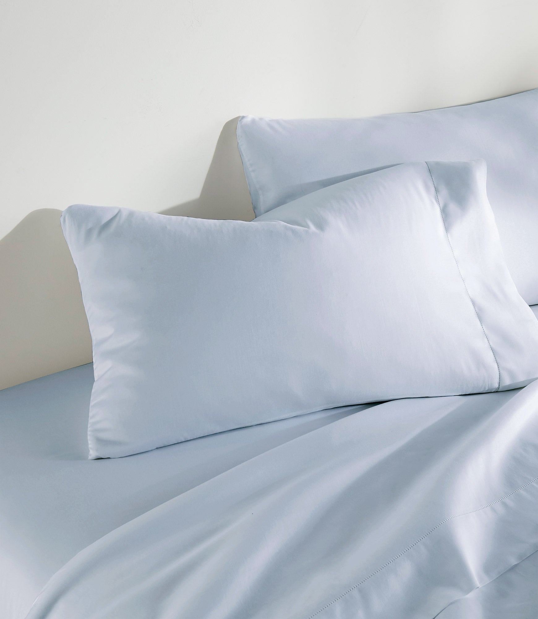 Clara Sateen Sheet Set on bed, Blue