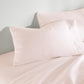 Clara Sateen Sheet Set on bed, Blush