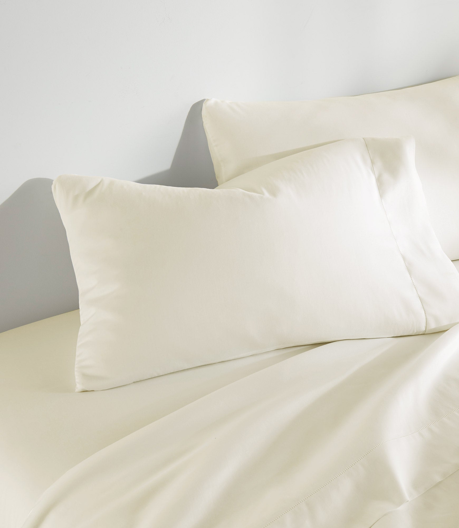 Clara Sateen Sheet Set on bed, Ivory