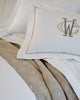 Boutique Percale Sham with a patterned beige duvet cover and embroidered monogrammed pillowcases.
