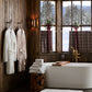 Cozy Waffle Robe hanging on cabin bathroom styled with Catalina Bath Towel and Tiffany Cloud Bath Rug