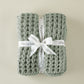 Cozy Waffle Throw wrapped in white ribbon tie, Sage