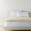 Wool Mattress Topper foot view with two white pillows atop the bed