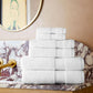Diamond bath towel set stacked on bathroom vanity, White