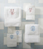 Set of White Diamond Towels with embroidered monograms on a light blue and white tiled background.