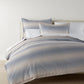 Elena Jacquard Duvet Cover on bed with matching shams, Blue