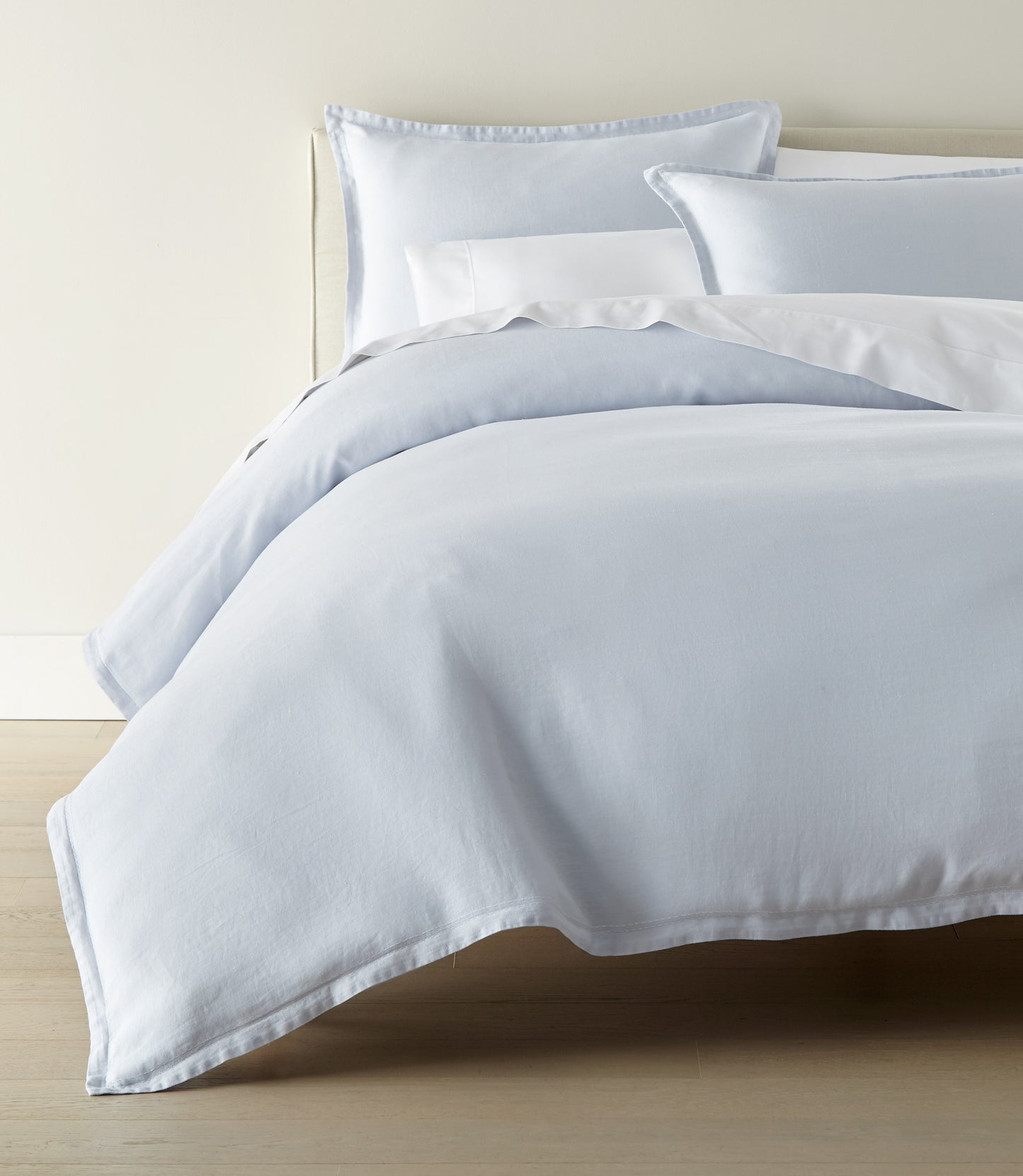European Washed Linen Sheet Set on a bed with a cream colored head board, Sky