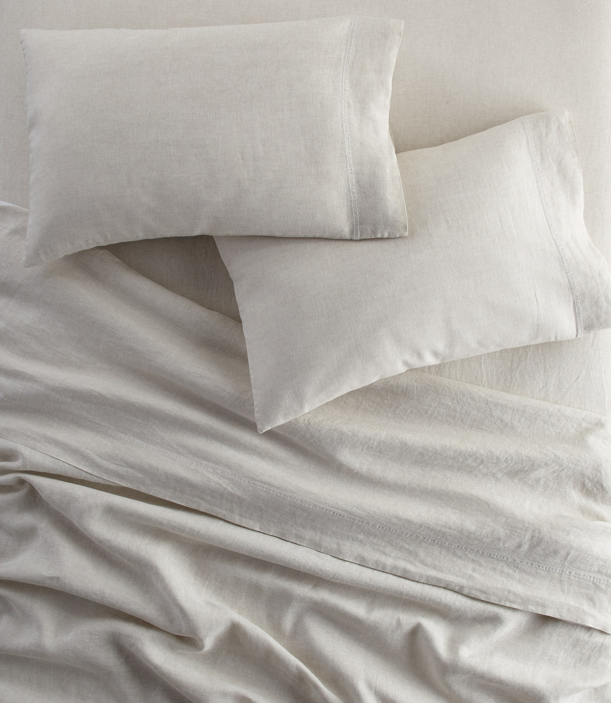 European Washed Linen Pillowcases and sheets on bed, Natural