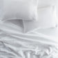 European Washed Linen Flat Sheet and pillows on bed, White