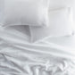 European Washed Linen Pillowcases and sheets on bed, White