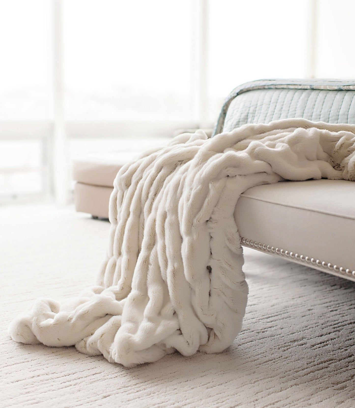 Mila Faux Fur Throw draped on couch, Ivory