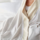 Favorite Cotton Blanket wrapped around woman on bed, White