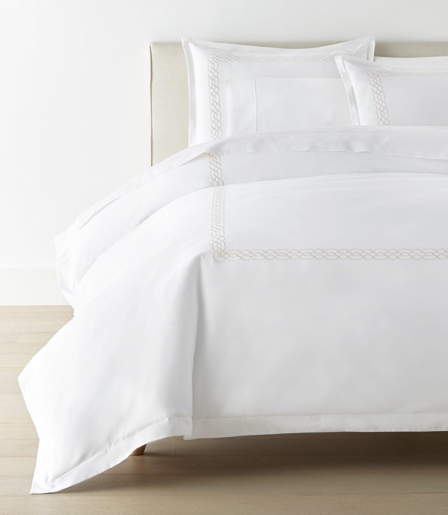 Filigree Duvet Set arranged on a bed against a white wall, Linen