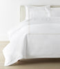 Filigree Duvet Set arranged on a bed against a white wall, Linen